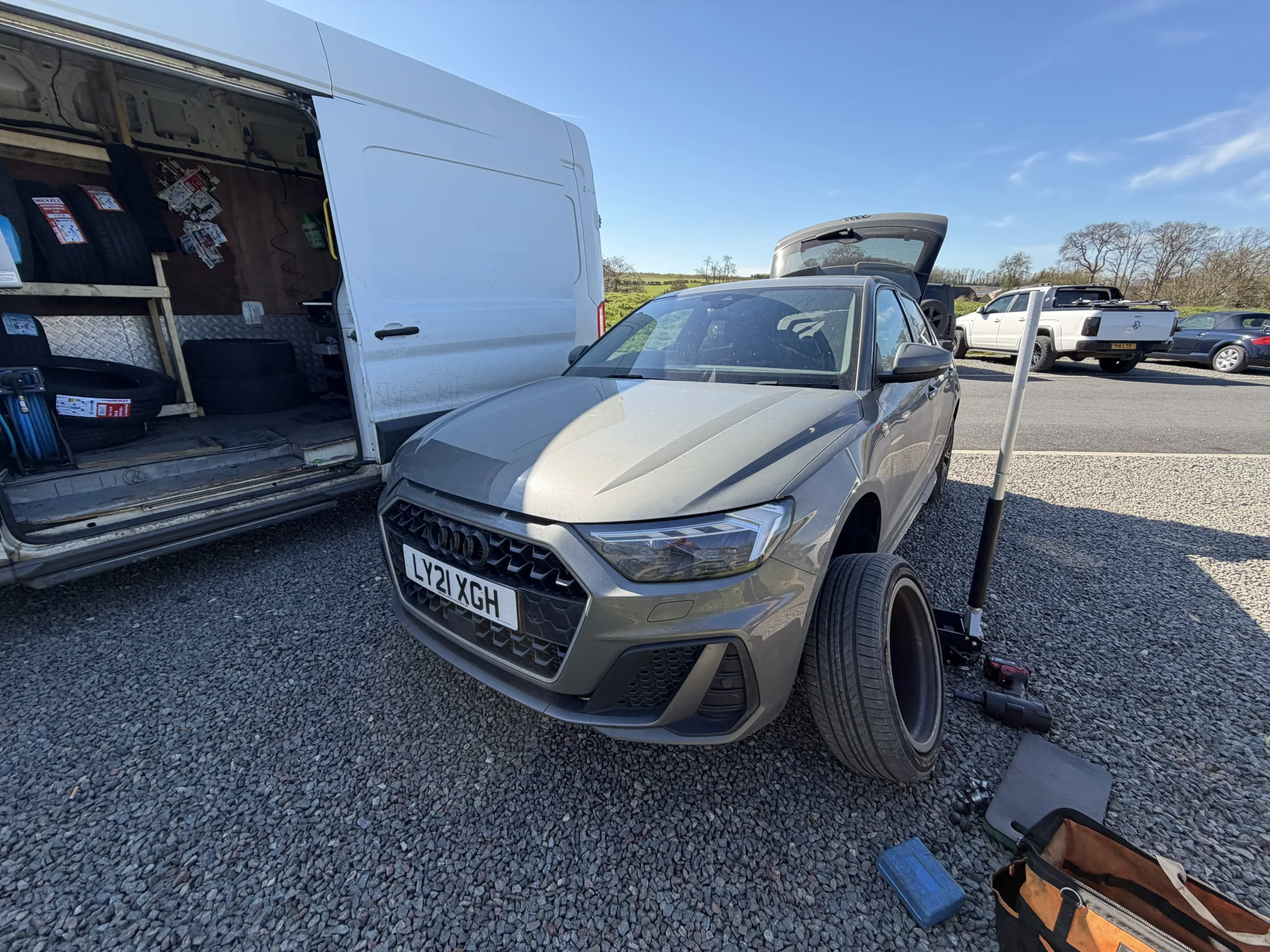 Tyre technician using equipment inside the fitting van